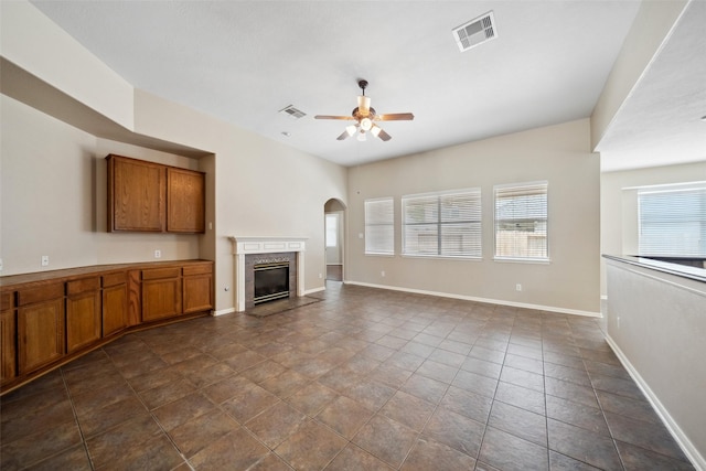 15331 Springhill Bend Ln, Cypress, TX 77429 - unfurnished living room with ceiling fan, a high end fireplace, and arched walkways