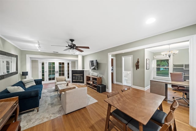 1621 Cherryhurst St, Houston, TX 77006 - living area with wood finished floors, a ceiling fan, french doors, a chandelier, and crown molding