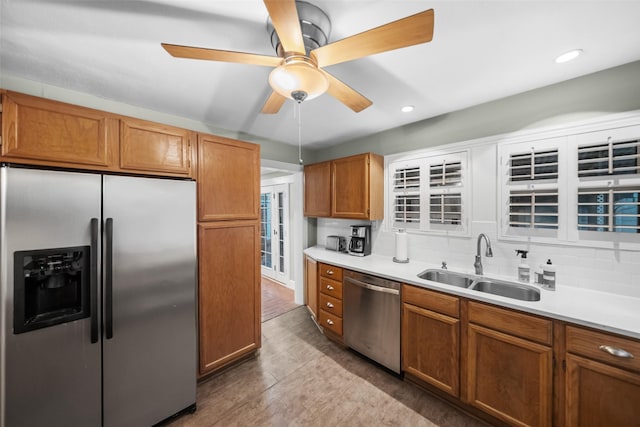 1621 Cherryhurst St, Houston, TX 77006 - kitchen with stainless steel appliances, ceiling fan, decorative backsplash, light countertops, and brown cabinets