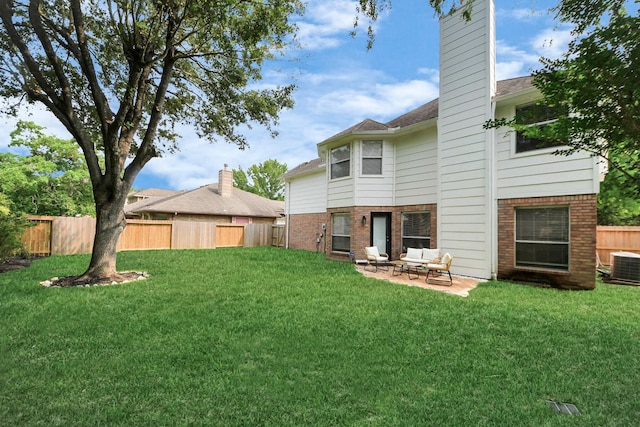 235 Cedar Elm Ln, Sugar Land, TX 77479 - rear view of property with brick siding, a fenced backyard, a patio, a chimney, and roof with shingles