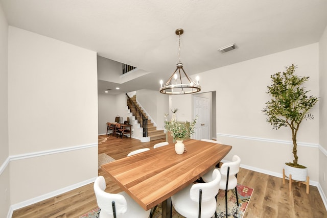 235 Cedar Elm Ln, Sugar Land, TX 77479 - dining area with stairway, a chandelier, and light wood finished floors
