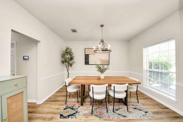 235 Cedar Elm Ln, Sugar Land, TX 77479 - dining room with light wood-style floors and a chandelier