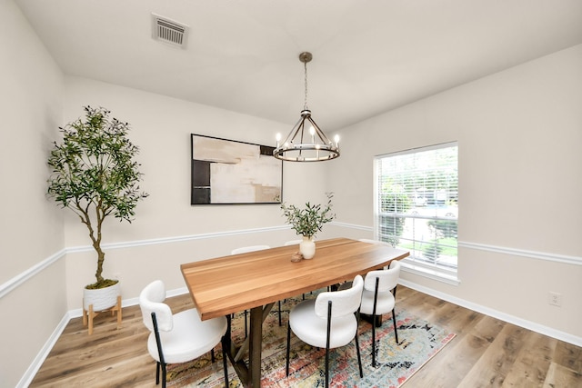 235 Cedar Elm Ln, Sugar Land, TX 77479 - dining room featuring light wood-style flooring and a chandelier