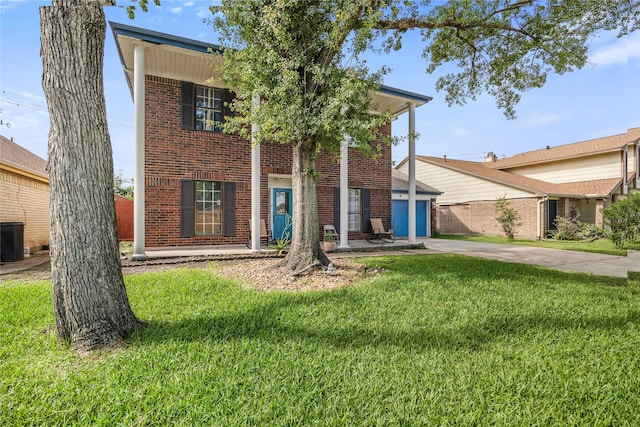 3825 Redbud Dr, La Porte, TX 77571 - view of front of home with brick siding, concrete driveway, a front yard, and a garage