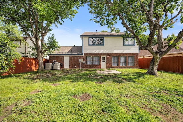 3825 Redbud Dr, La Porte, TX 77571 - rear view of property with brick siding, a fenced backyard, and a patio
