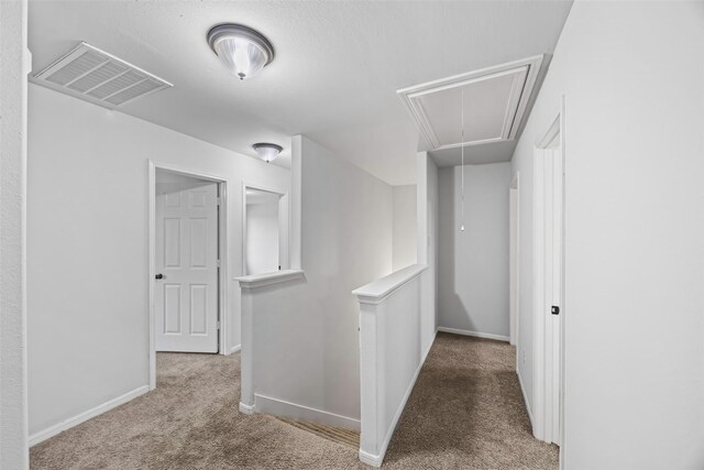 9203 Sasson Blvd, Houston, TX 77044 - hallway with attic access, carpet floors, and an upstairs landing
