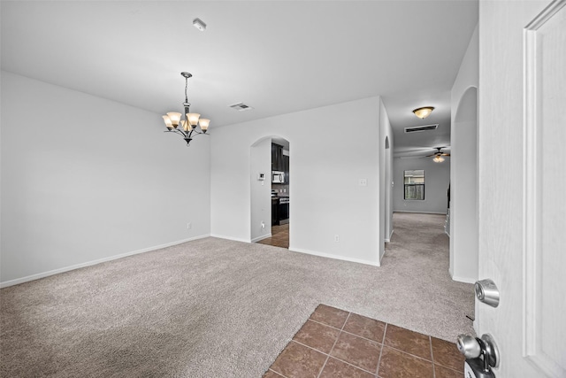 9203 Sasson Blvd, Houston, TX 77044 - unfurnished room featuring dark carpet, arched walkways, a chandelier, ceiling fan, and dark tile patterned floors