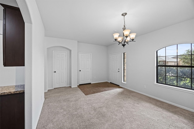 9203 Sasson Blvd, Houston, TX 77044 - carpeted spare room with a chandelier and arched walkways