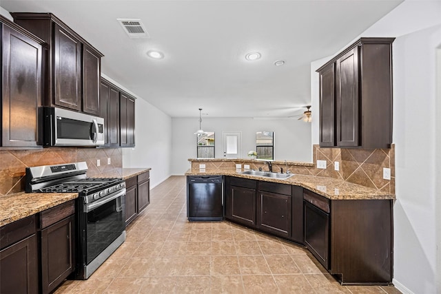9203 Sasson Blvd, Houston, TX 77044 - kitchen featuring appliances with stainless steel finishes, dark brown cabinetry, tasteful backsplash, light stone counters, and recessed lighting