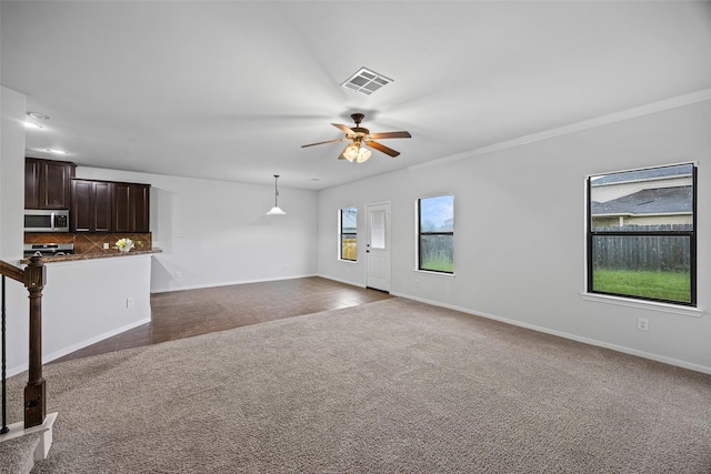 9203 Sasson Blvd, Houston, TX 77044 - unfurnished living room featuring dark carpet, a ceiling fan, and crown molding