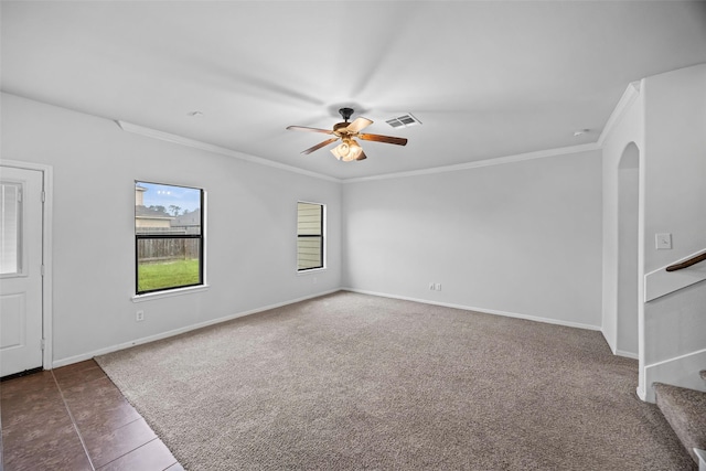 9203 Sasson Blvd, Houston, TX 77044 - tiled spare room featuring a ceiling fan, arched walkways, crown molding, stairs, and carpet floors