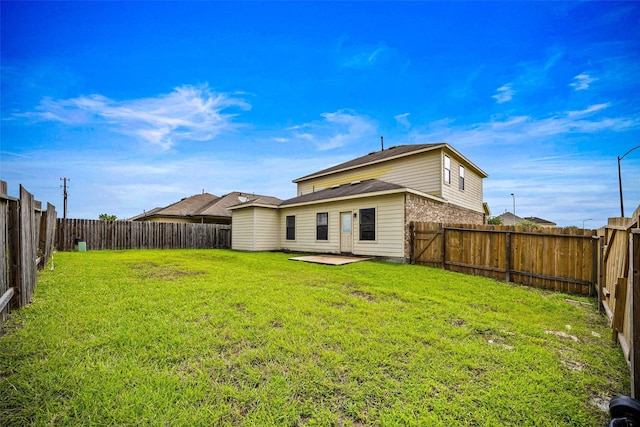 9203 Sasson Blvd, Houston, TX 77044 - rear view of house with a fenced backyard and a patio area