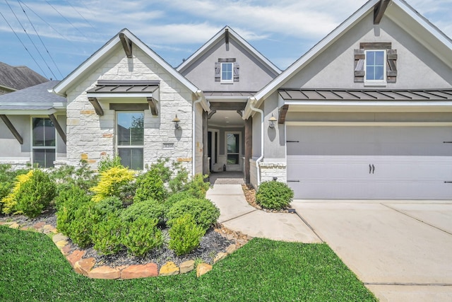 31268 New Forest Park Ln, Spring, TX 77386 - view of front of house featuring stone siding, a standing seam roof, driveway, and a garage