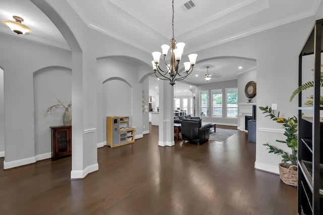 31268 New Forest Park Ln, Spring, TX 77386 - entrance foyer featuring dark wood-type flooring, a fireplace, a chandelier, crown molding, and arched walkways
