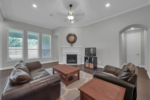 31268 New Forest Park Ln, Spring, TX 77386 - living area with arched walkways, a ceiling fan, a glass covered fireplace, recessed lighting, and ornamental molding