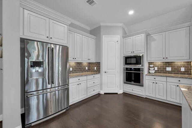 31268 New Forest Park Ln, Spring, TX 77386 - kitchen featuring stainless steel appliances, crown molding, dark wood-style flooring, backsplash, and white cabinetry