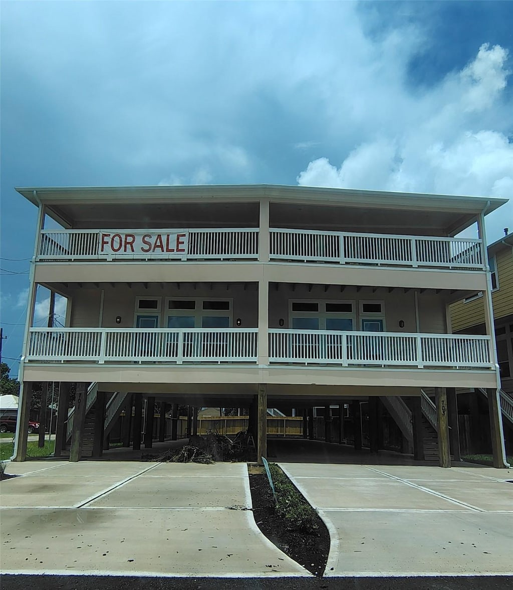 701 Bayshore Dr, La Porte, TX 77571 - view of building exterior featuring stairs and a carport