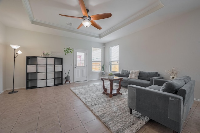 5830 Acacia Rose Ct, Richmond, TX 77407 - living area with a tray ceiling, ceiling fan, ornamental molding, and light tile patterned flooring