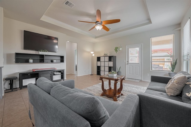 5830 Acacia Rose Ct, Richmond, TX 77407 - living room with a raised ceiling, light tile patterned floors, a ceiling fan, and crown molding