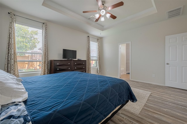 5830 Acacia Rose Ct, Richmond, TX 77407 - bedroom featuring a raised ceiling, ornamental molding, multiple windows, wood finished floors, and ensuite bathroom