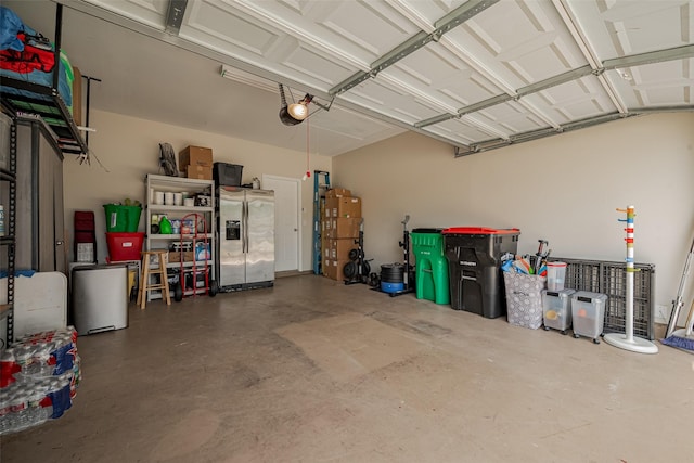5830 Acacia Rose Ct, Richmond, TX 77407 - garage featuring stainless steel fridge and a garage door opener