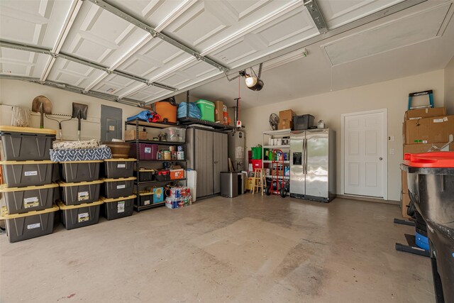 5830 Acacia Rose Ct, Richmond, TX 77407 - garage with stainless steel fridge, a garage door opener, and electric panel