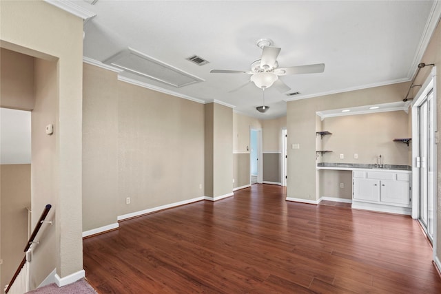 119 8th St, San Leon, TX 77539 - unfurnished living room with a ceiling fan, wood finished floors, ornamental molding, attic access, and healthy amount of natural light