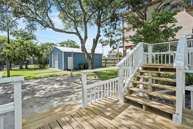 119 8th St, San Leon, TX 77539 - wooden terrace with a detached garage, stairs, an outbuilding, driveway, and a patio area