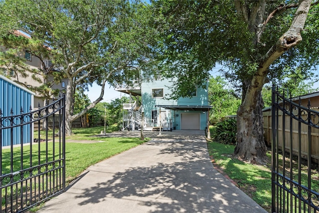 119 8th St, San Leon, TX 77539 - view of front of home featuring stairway, an attached garage, and concrete driveway