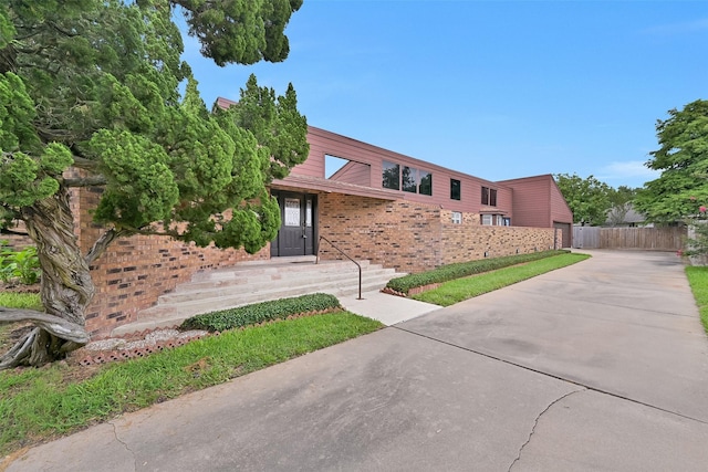 12 E Dansby Dr, Galveston, TX 77551 - mid-century home with driveway and brick siding