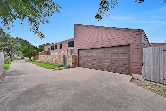 12 E Dansby Dr, Galveston, TX 77551 - garage with driveway and a gate