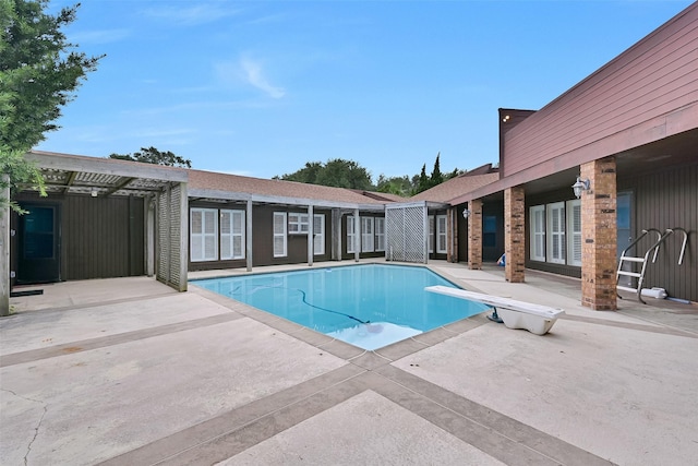 12 E Dansby Dr, Galveston, TX 77551 - swimming pool with a patio and a diving board