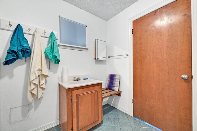 12 E Dansby Dr, Galveston, TX 77551 - bathroom with vanity and a textured ceiling