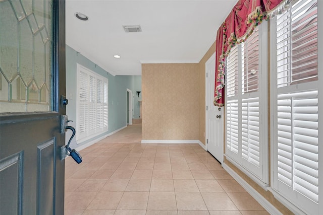12 E Dansby Dr, Galveston, TX 77551 - foyer with crown molding, light tile patterned flooring, and recessed lighting