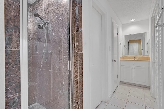 12 E Dansby Dr, Galveston, TX 77551 - full bathroom featuring a shower stall, vanity, tile patterned floors, a textured ceiling, and recessed lighting