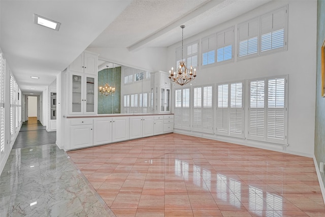 12 E Dansby Dr, Galveston, TX 77551 - unfurnished dining area featuring a chandelier and light marble finish floors
