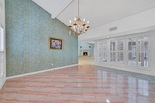 12 E Dansby Dr, Galveston, TX 77551 - empty room featuring wallpapered walls, a chandelier, and high vaulted ceiling