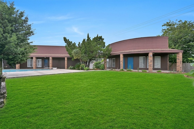12 E Dansby Dr, Galveston, TX 77551 - view of front of house with an outdoor pool, a front yard, and brick siding