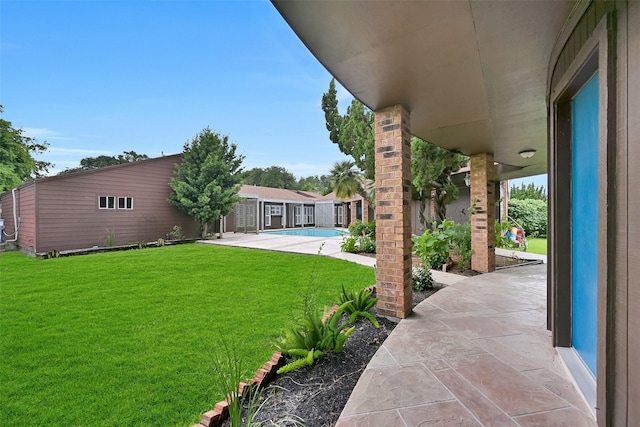12 E Dansby Dr, Galveston, TX 77551 - view of grassy yard with a patio area and an outdoor pool
