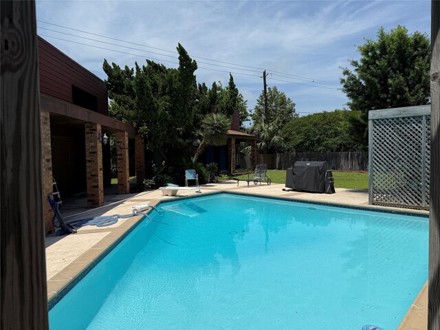 12 E Dansby Dr, Galveston, TX 77551 - view of swimming pool featuring a grill and a patio