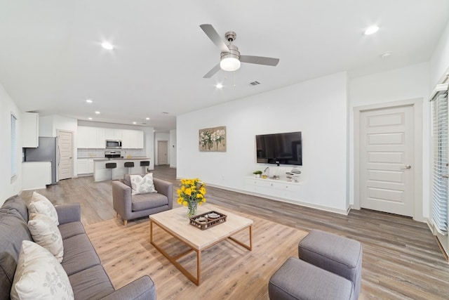 7002 Halifax Harvest Ln, Richmond, TX 77407 - living room featuring recessed lighting, ceiling fan, and light wood-type flooring