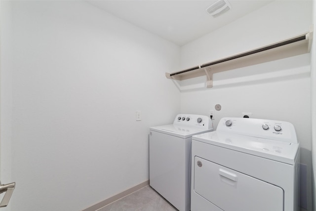 7002 Halifax Harvest Ln, Richmond, TX 77407 - washroom with separate washer and dryer and light tile patterned flooring