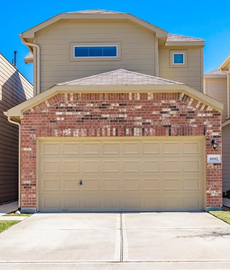 6042 Wesley Manor Ct, Katy, TX 77449 - view of front of property with brick siding, concrete driveway, and a garage