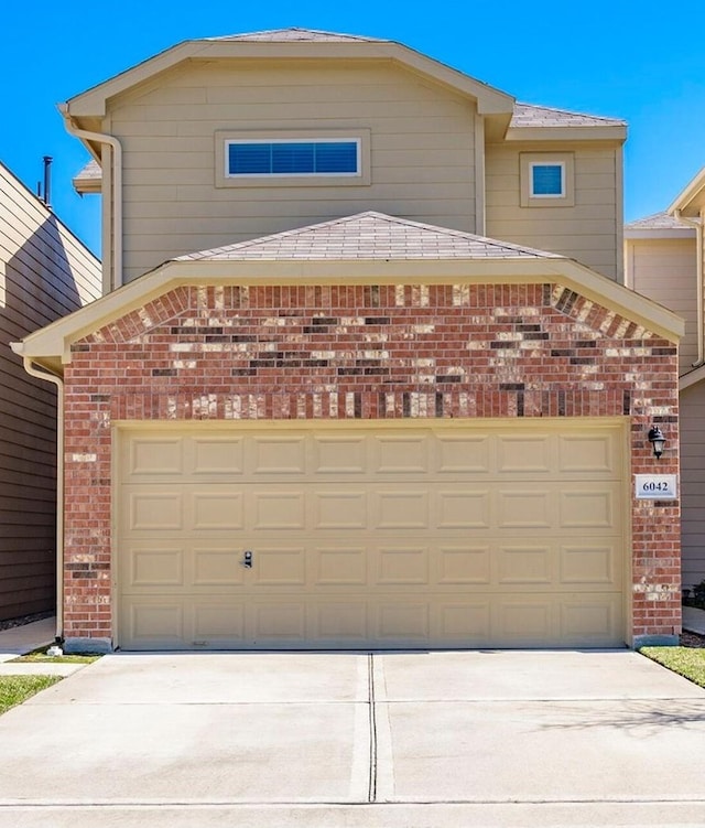 6042 Wesley Manor Ct, Katy, TX 77449 - view of front of property with brick siding, concrete driveway, and a garage