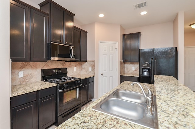 6042 Wesley Manor Ct, Katy, TX 77449 - kitchen with black appliances, dark brown cabinets, tasteful backsplash, and recessed lighting