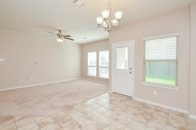 6042 Wesley Manor Ct, Katy, TX 77449 - foyer featuring light colored carpet, a ceiling fan, a chandelier, and light tile patterned floors