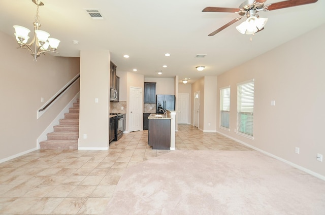 6042 Wesley Manor Ct, Katy, TX 77449 - kitchen featuring black appliances, backsplash, a kitchen island with sink, open floor plan, and a chandelier