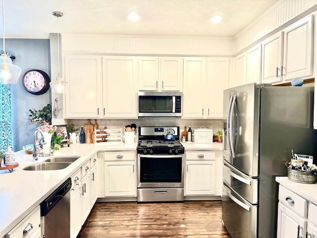 20809 Langworth Pl, Porter, TX 77365 - kitchen with stainless steel appliances, light countertops, white cabinets, backsplash, and wood finished floors