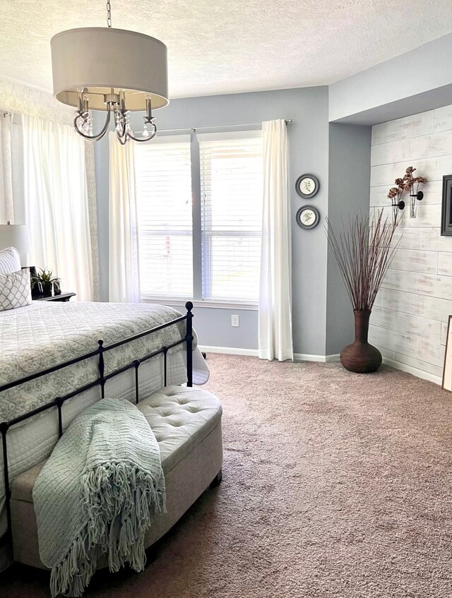 20809 Langworth Pl, Porter, TX 77365 - bedroom with carpet flooring, a textured ceiling, a chandelier, and wooden walls