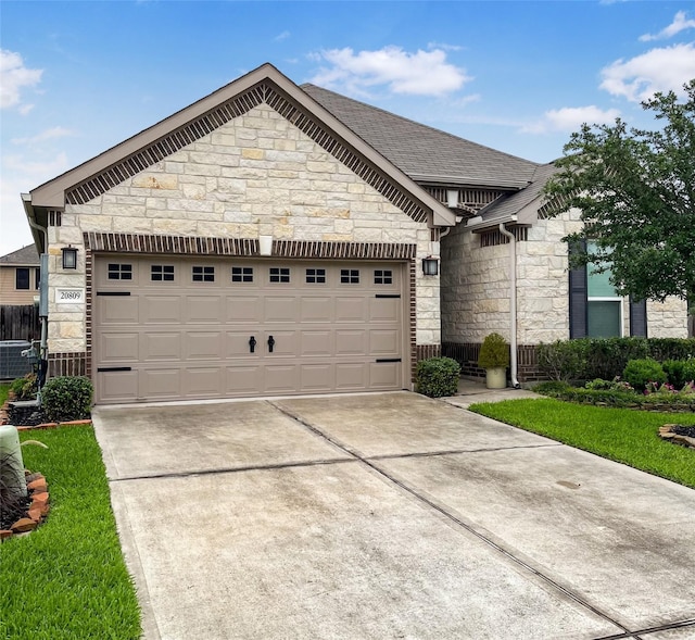20809 Langworth Pl, Porter, TX 77365 - french country style house with stone siding, driveway, a garage, and a shingled roof